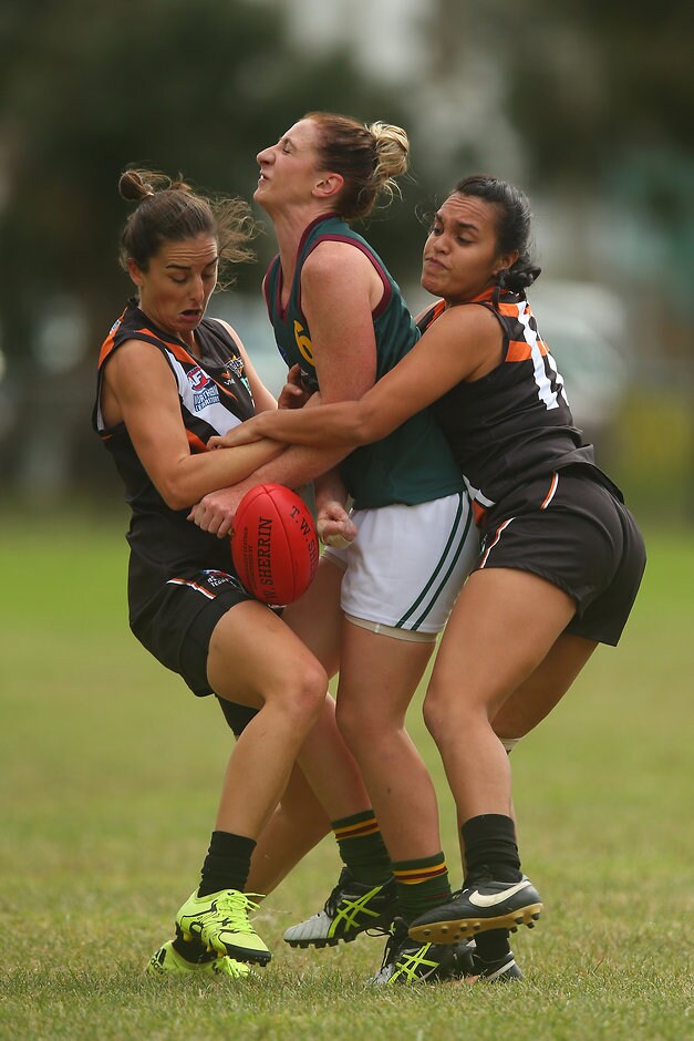AFL 2016 Media - Womens Match Northern Territory v Tasmania MELBOURNE, AUSTRALIA - APRIL 10: Zoie Crawford of Tasmania (C) is tackled on during the Women's Exhibition match between Northern Territory and Tasmania at Peanut Farm Reserve on April 10, 2016 in Melbourne, Australia. (Photo by Graham Denholm/AFL Media/)